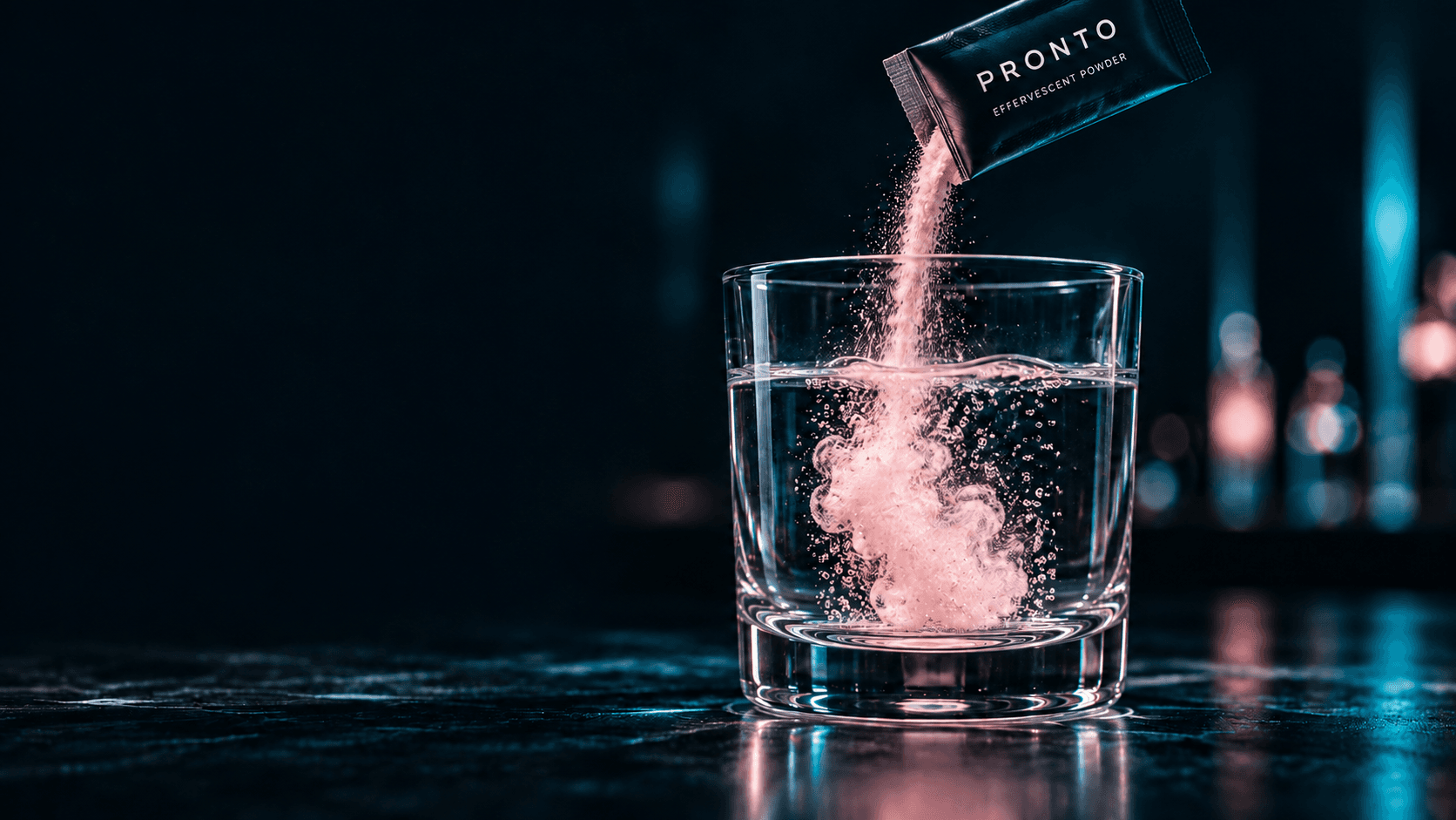 Pink effervescent powder pouring from a Pronto sachet into a glass of water